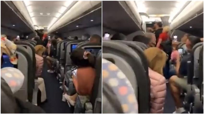 Pasajeros aplauden y cantan mientras bajan de un vuelo a varias personas sin máscara en el Aeropuerto de Miami